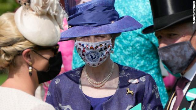 Princess Anne wore a deep blue ensemble with a bespoke face covering on the first day of Royal Ascot. 