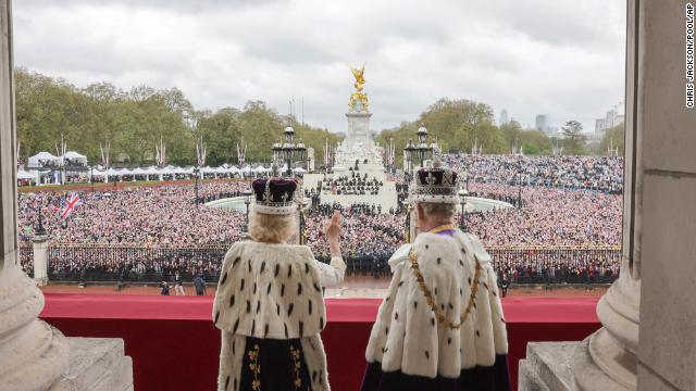 The newly crowned monarch and his wife wave to the crowd.