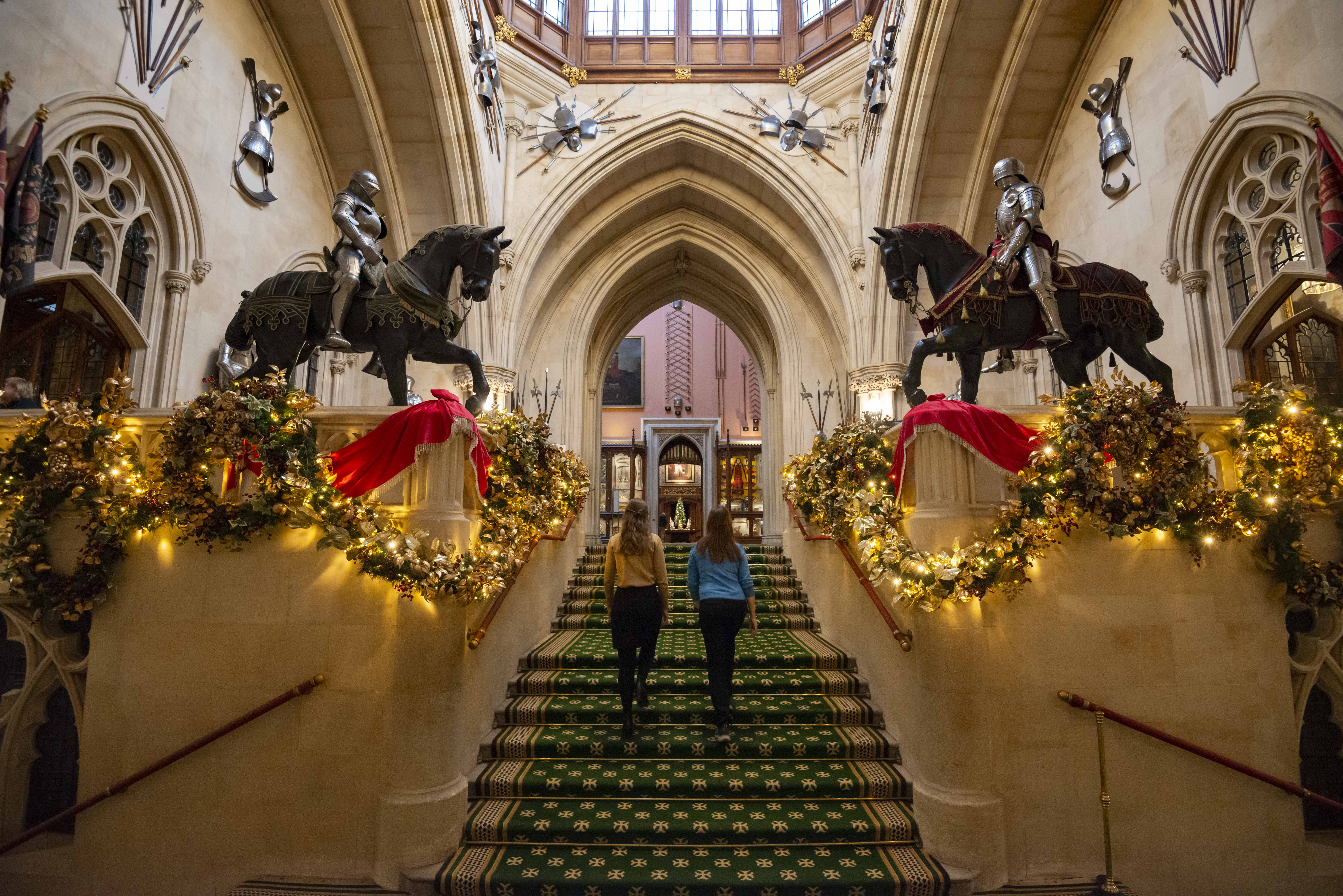 Two people ascend the Grand Staircase in Windsor Castle