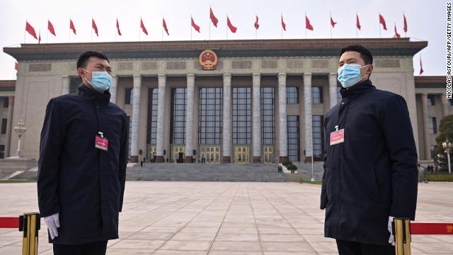 Security personnel stand guard outside the Great Hall of the People ahead of the closing session of the National Peoples Congress in Beijing on March 11.