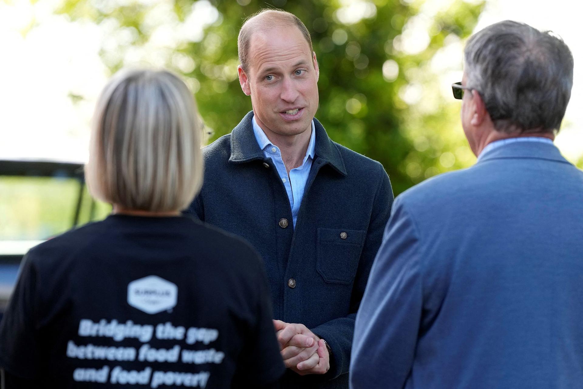 Prince William is greeted as he arrives at a surplus food redistribution charity