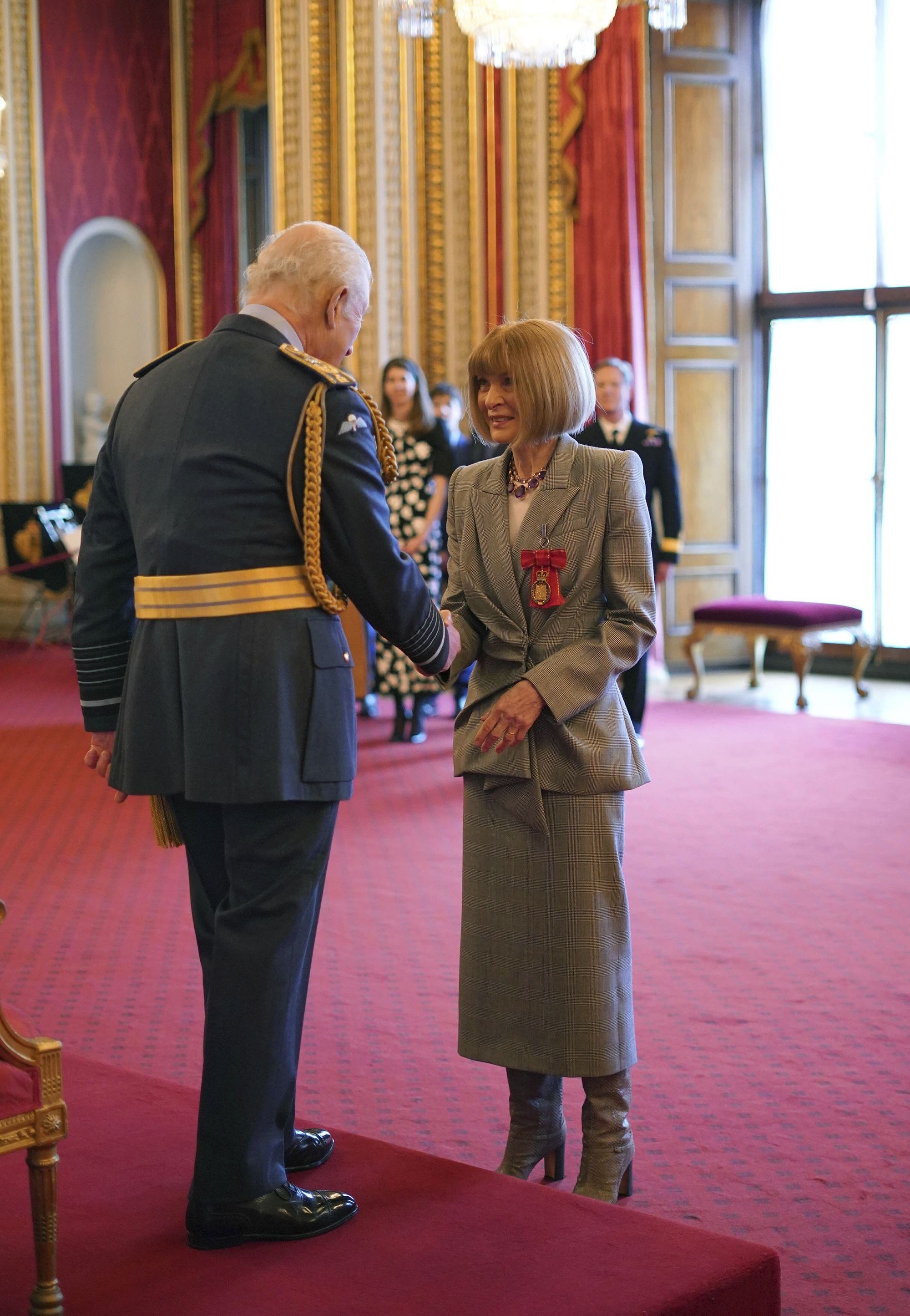 Anna Wintour shakes hands with King Charles at Buckingham Palace, after the fashion magazine editor was made a Companion of Honour