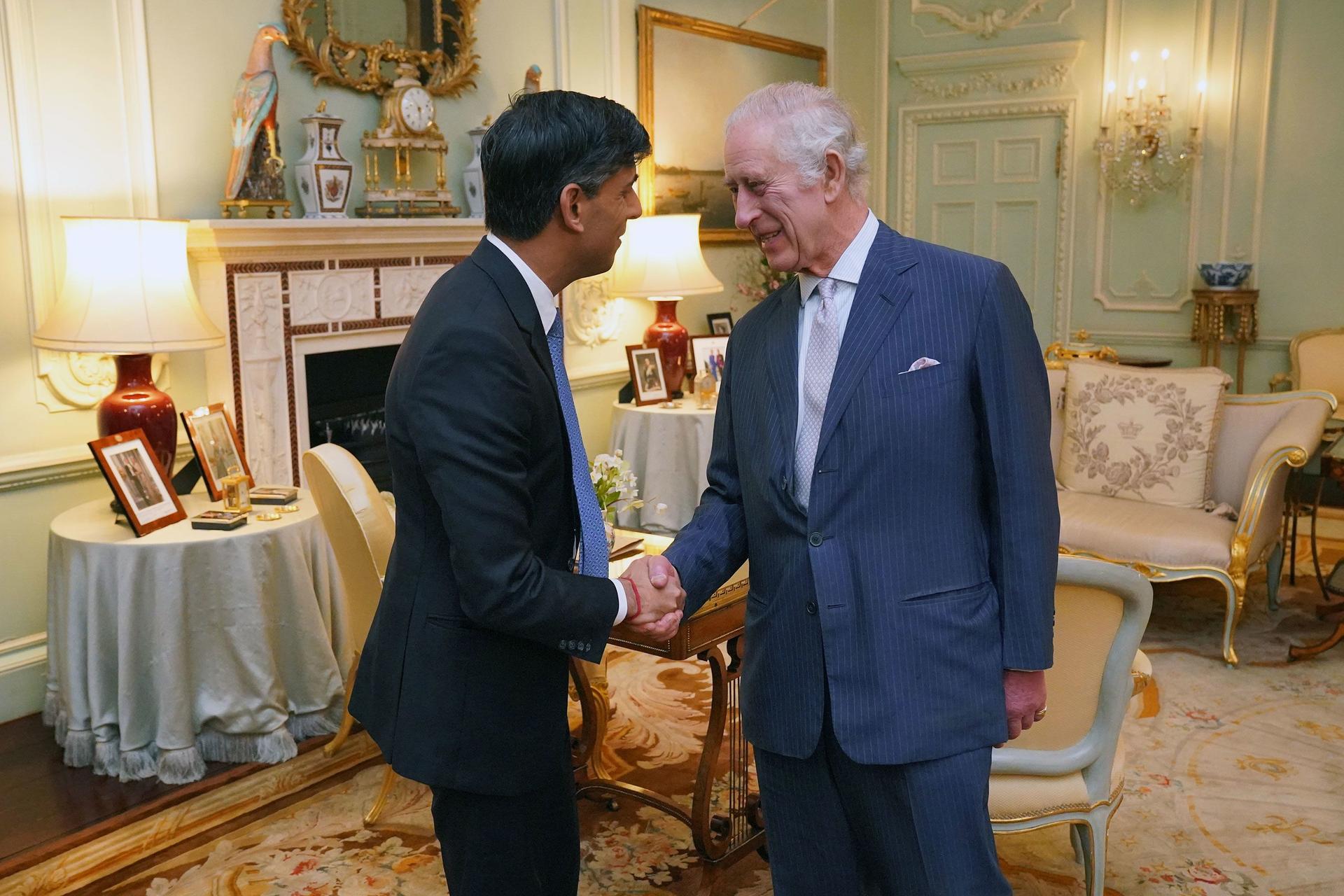 King Charles III shakes hands with UK Prime Minister Rishi Sunak