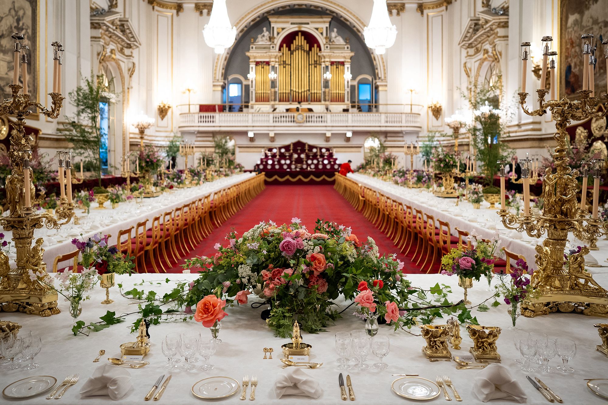 Floral arrangements and table settings at an enormous table in the ballroom of Buckingham Palace ahead of a State Banquet on the first day of a three-day State Visit by Japan's Emperor and Empress to Britain on June 25, 2024.