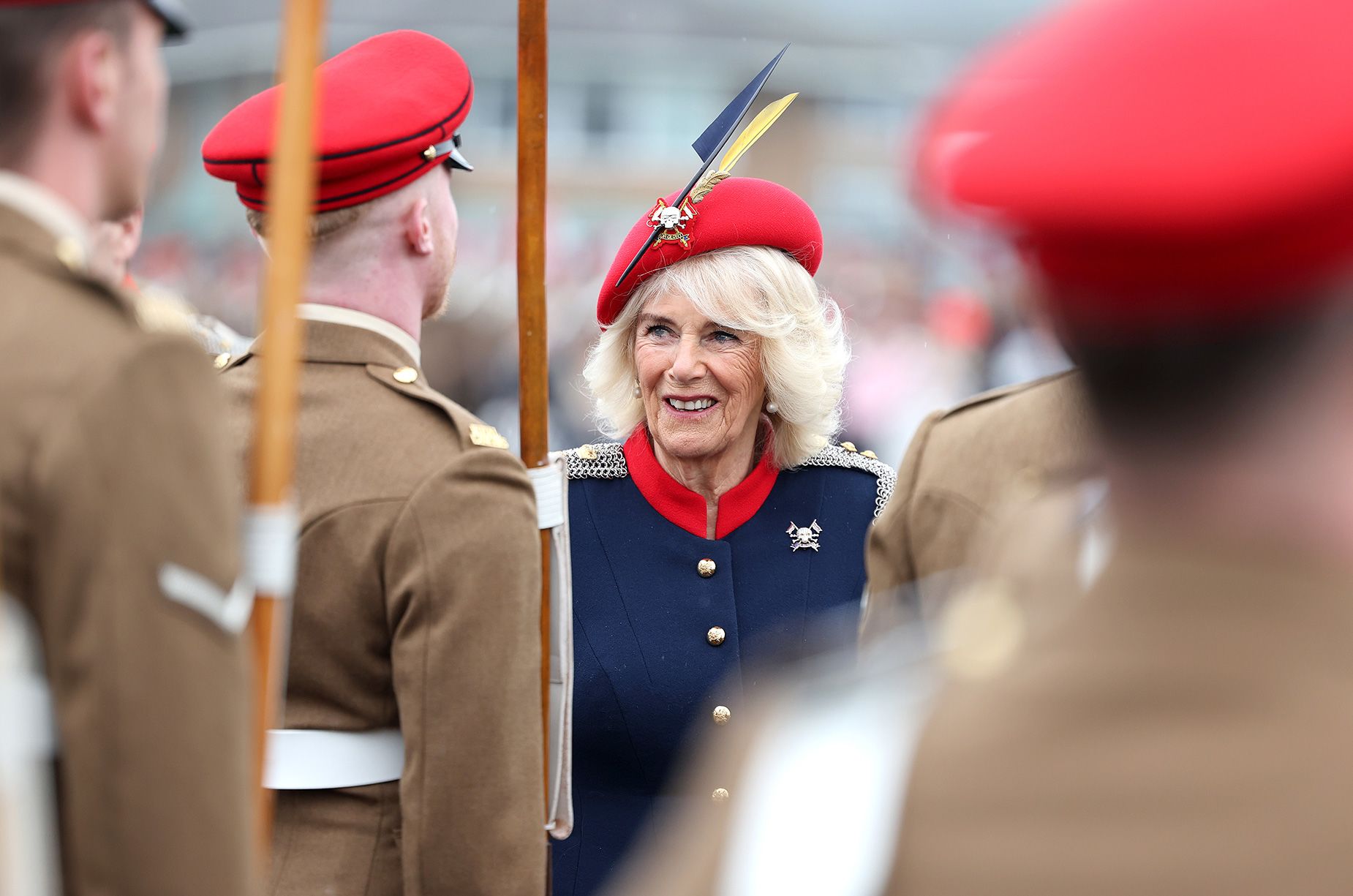 Photo of Queen Camilla smiling during a visit to The Royal Lancers