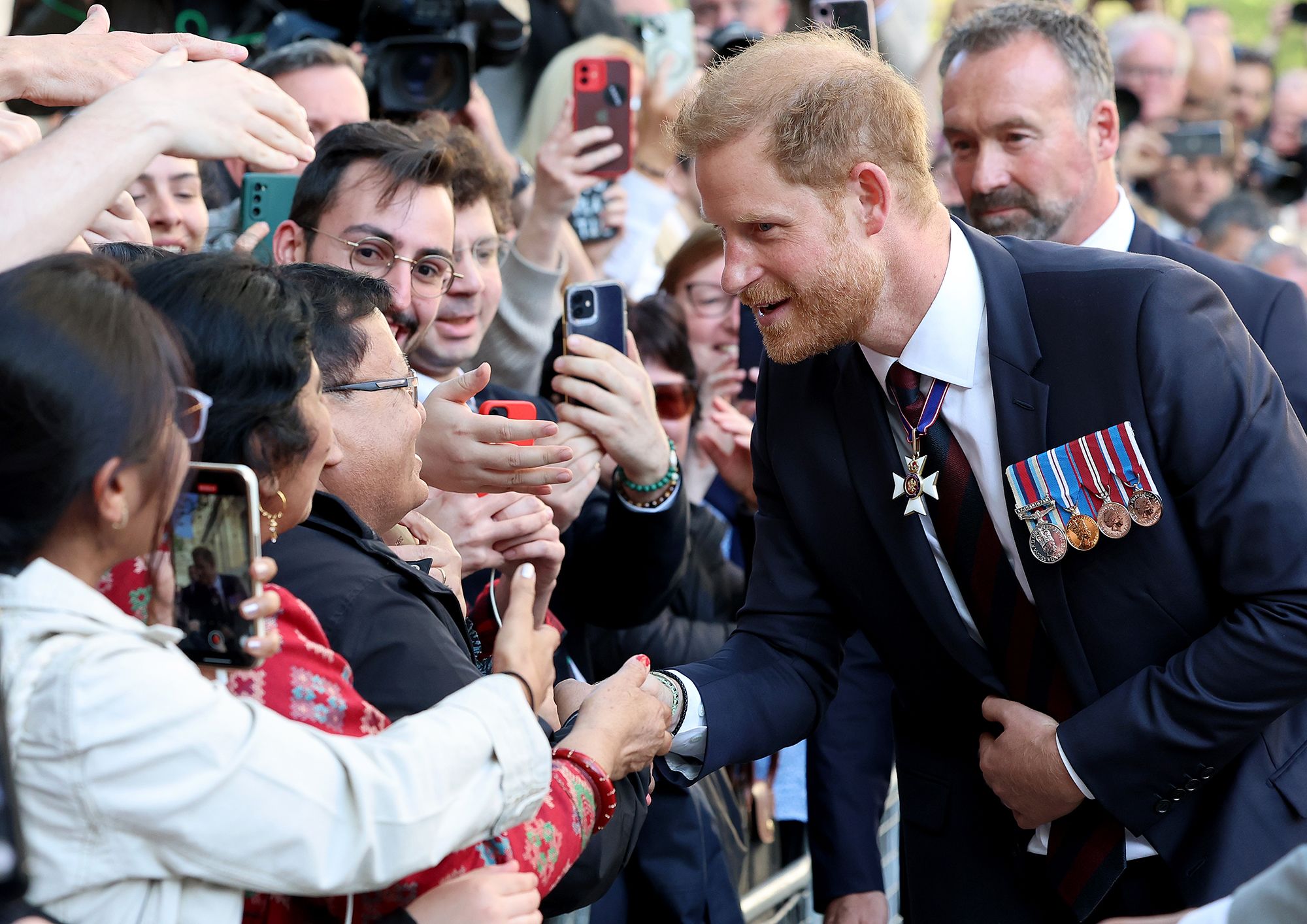 Prince Harry shakes hands with members of the public