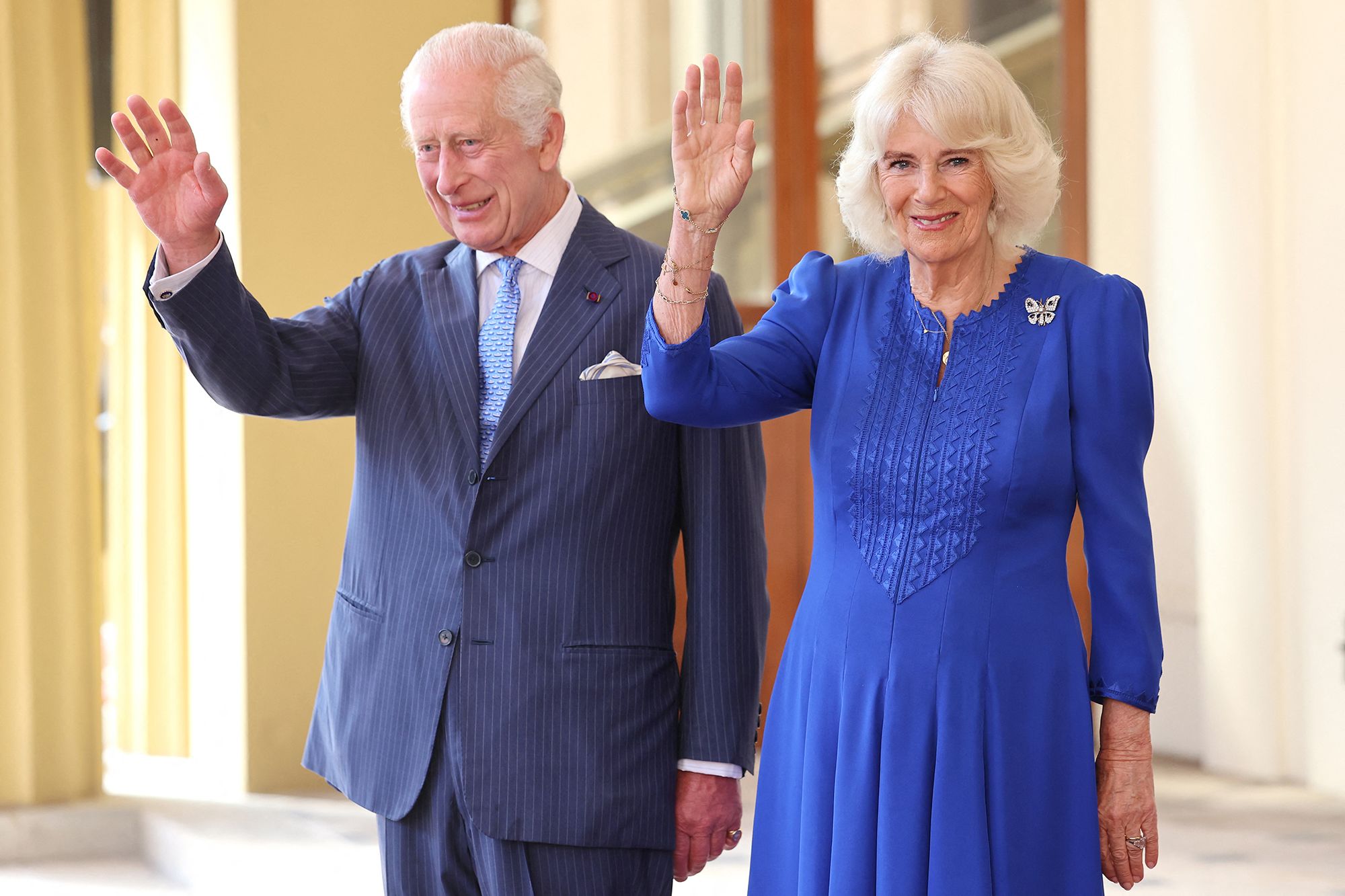 Photo of King Charles and Queen Camilla waving