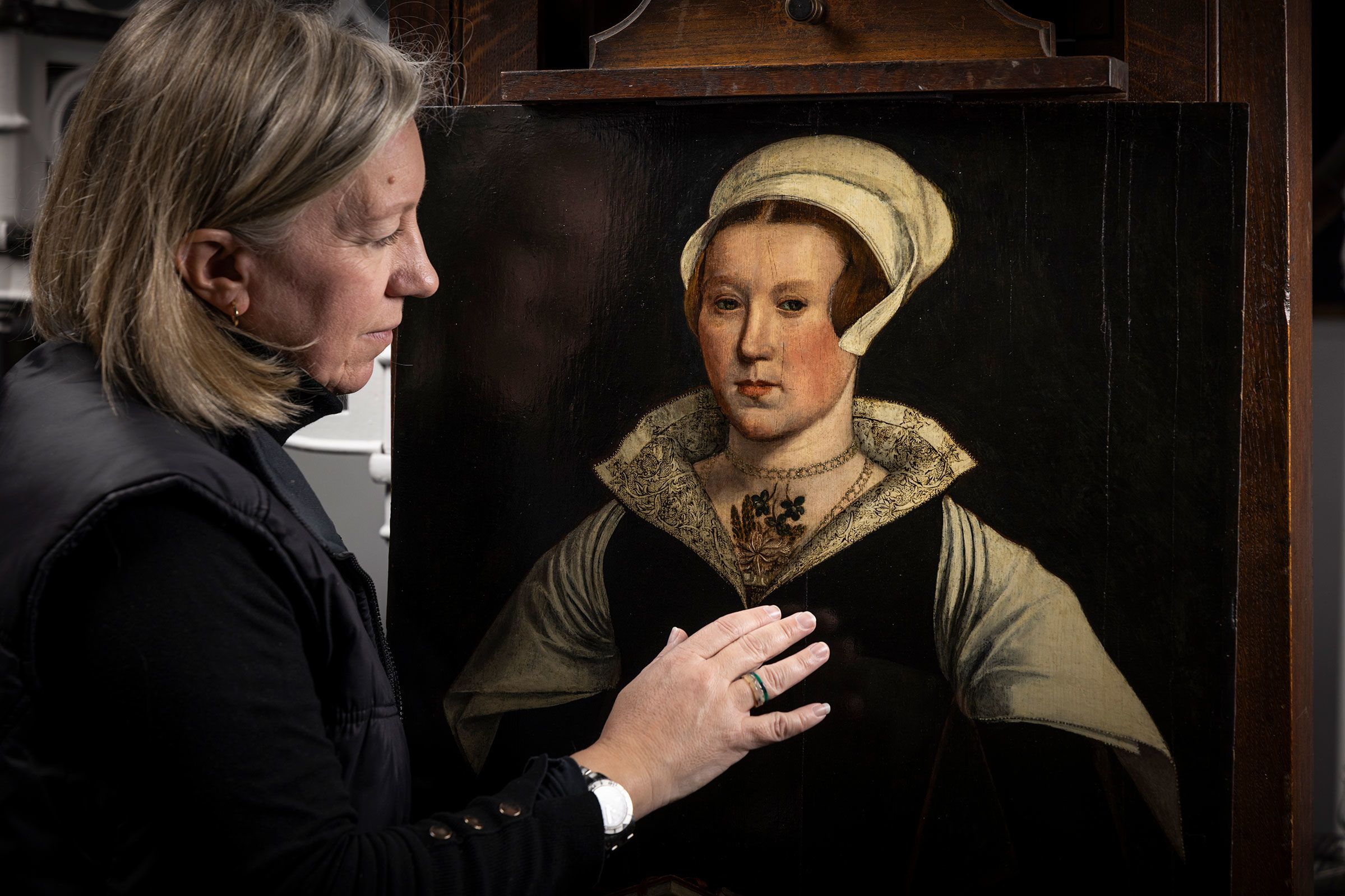 Conservator Rachel Turnbull gives the mysterious portrait a final examination before it goes on display