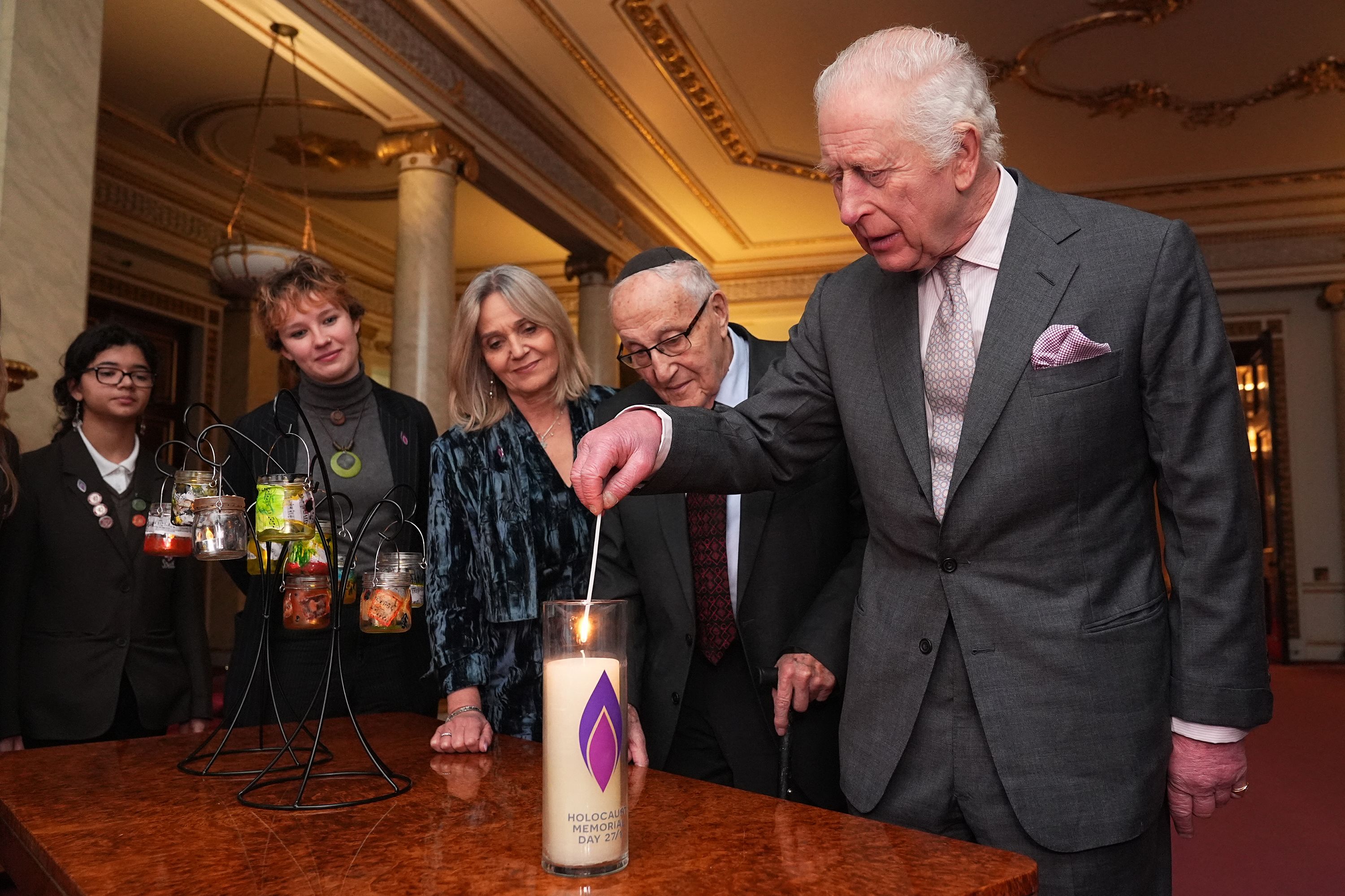 King Charles lights a candle during a reception marking Holocaust Memorial Day 