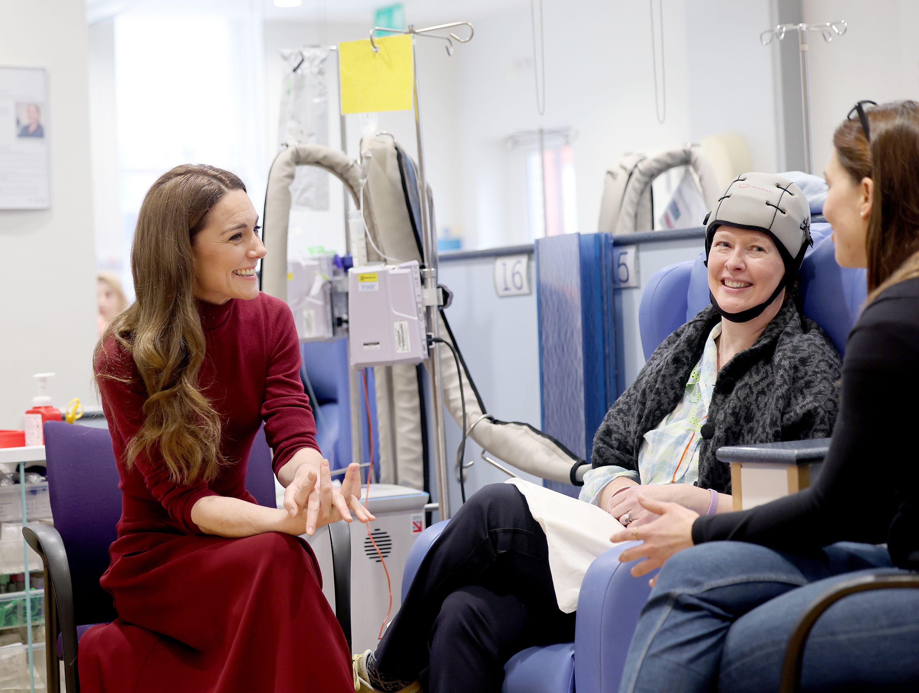 Princess Kate smiles while chatting with a patient during a visit to London's Royal Marsden Hospital 