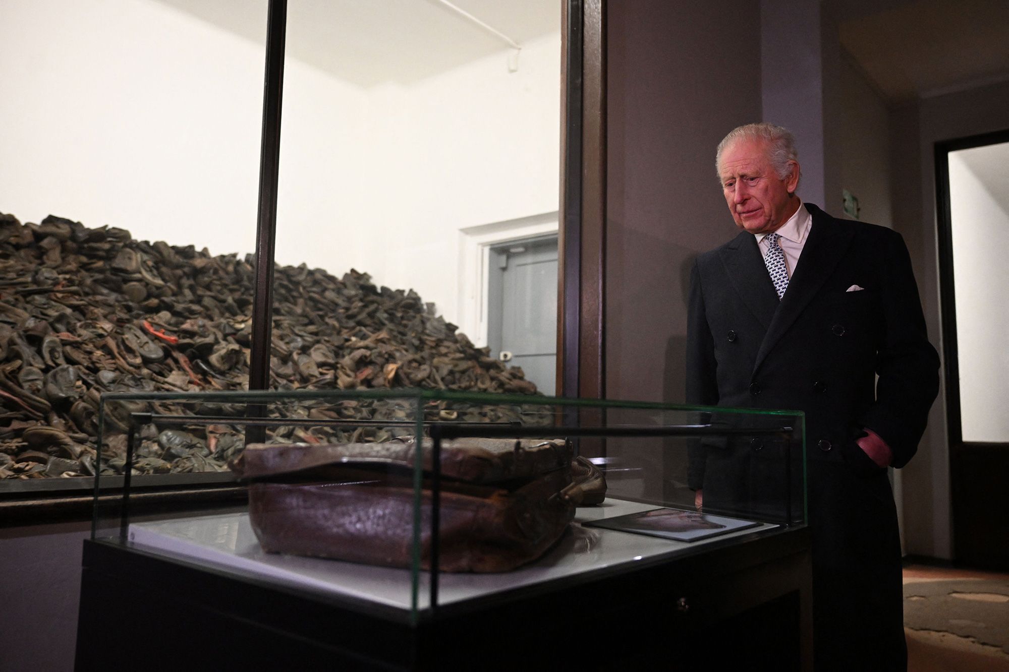 King Charles looks at the belongings of people who were deported to Auschwitz