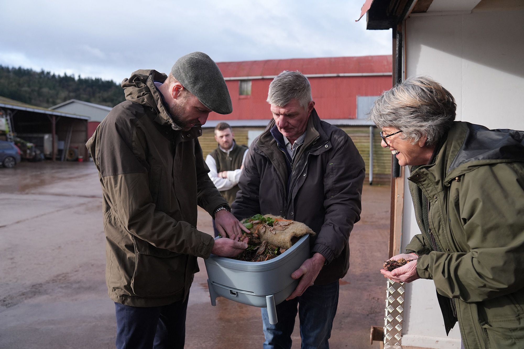 Prince William holds a worm during a trip to an eco farm