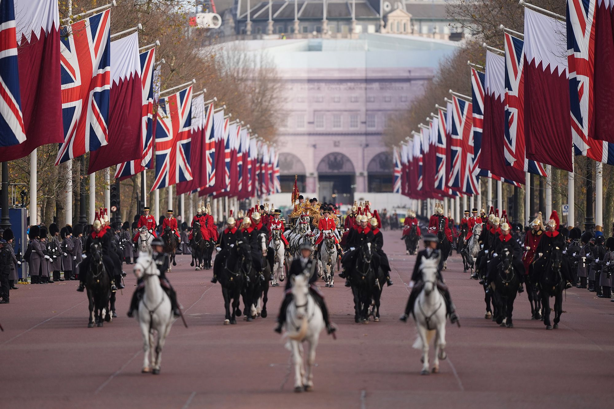 King Charles travels in the Irish State Coach with the Emir of Qatar Sheikh Tamim bin Hamad Al Thani and his wife along The Mall to Buckingham Palace in London.