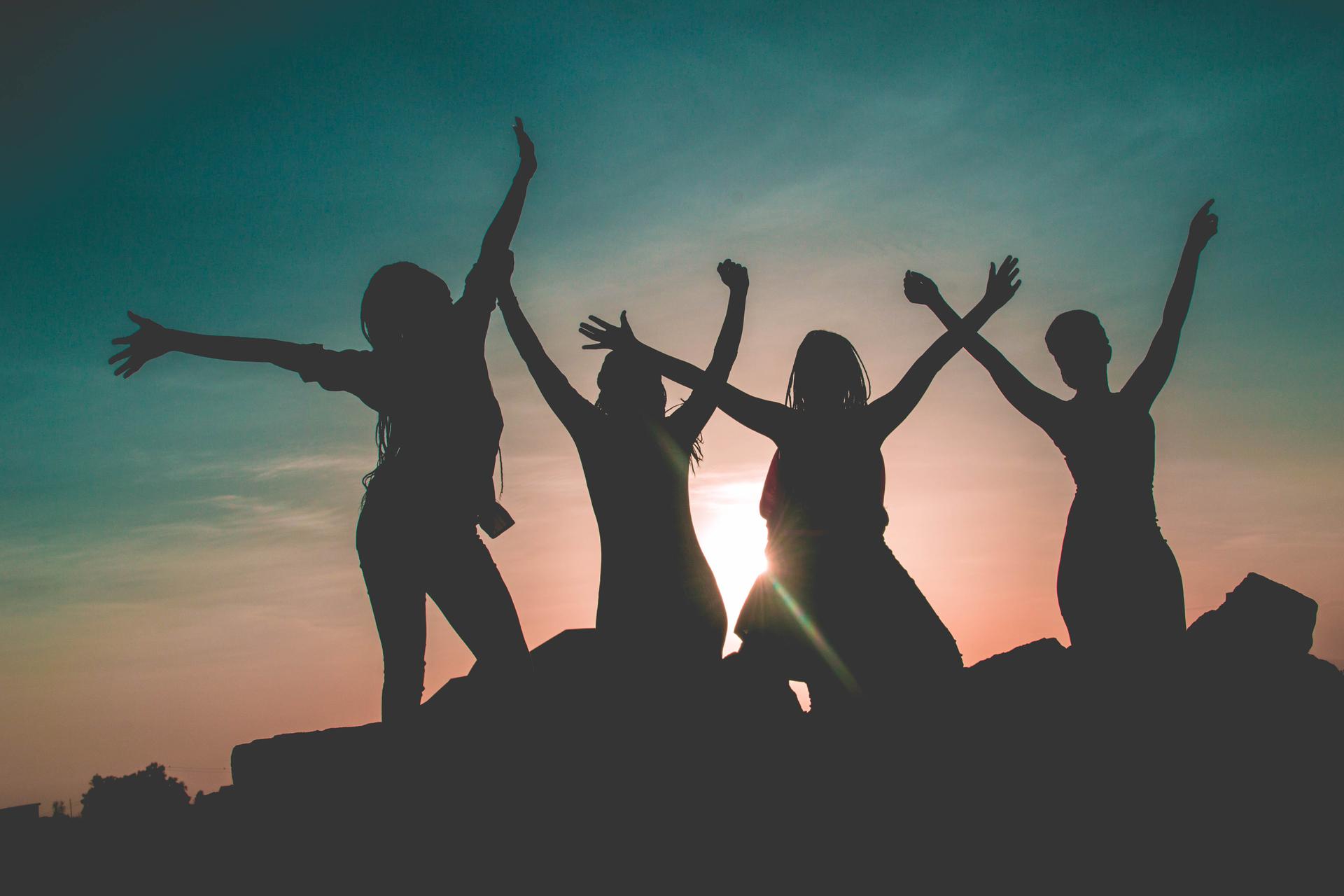 Image of four friends in celebration . Source: Pexels