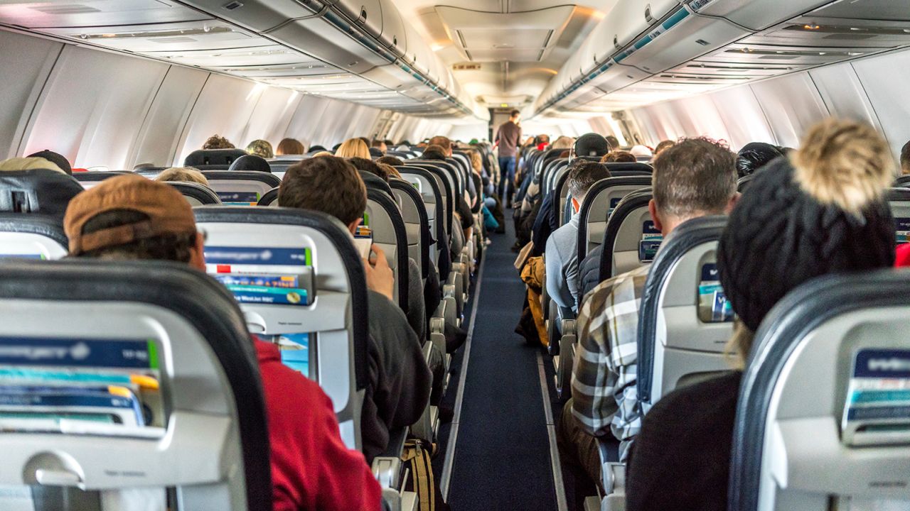 People seated inside an airplane.