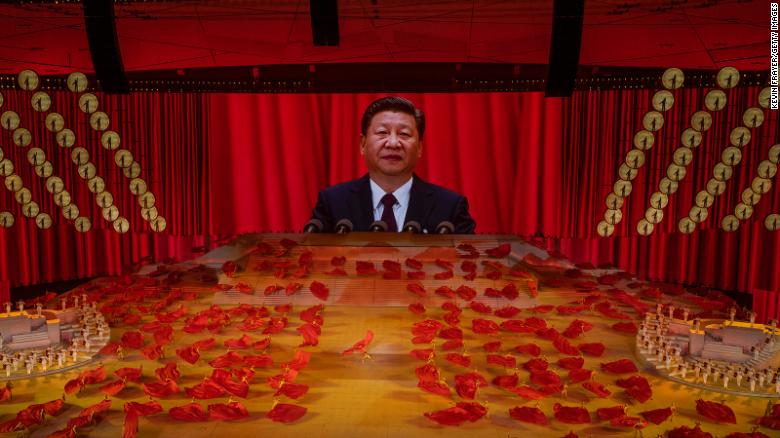 Chinese President Xi Jinping appears on a large screen during a dance performance at a mass gala marking the 100th anniversary of the Communist Party in Beijing.