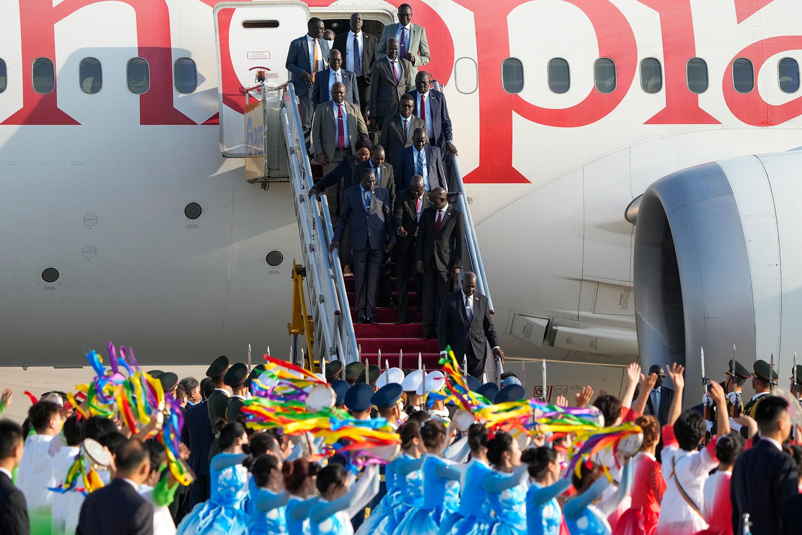 South Sudan delegation members are welcomed by honor guard and dancers as they arrive at the Beijing Capital International Airport to attend the China Africa Forum in Beijing on Monday.