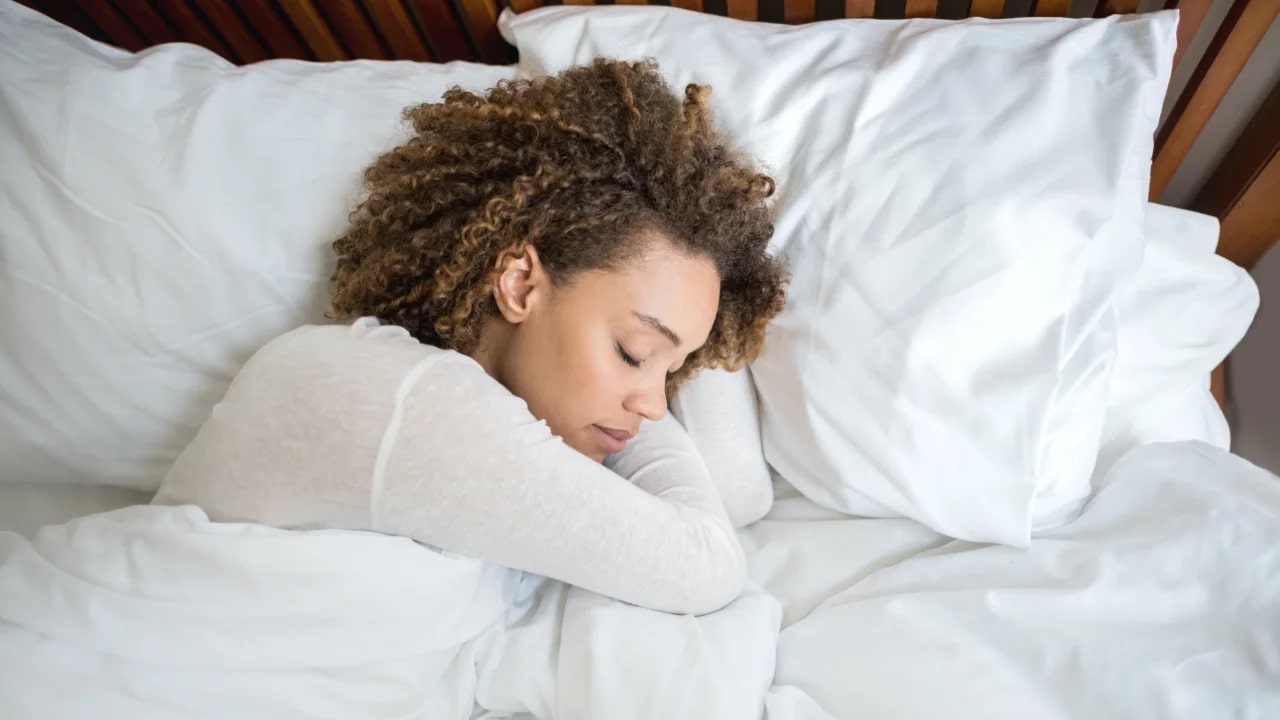 Person sleeping on a white pillow