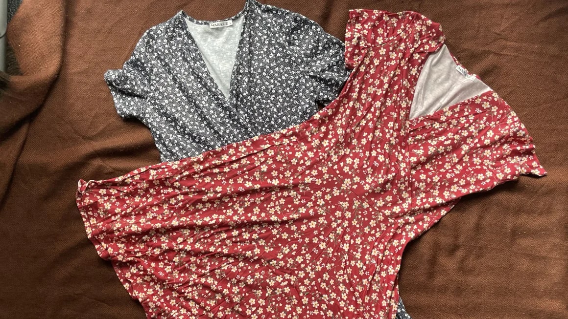 Two floral dresses laying flat