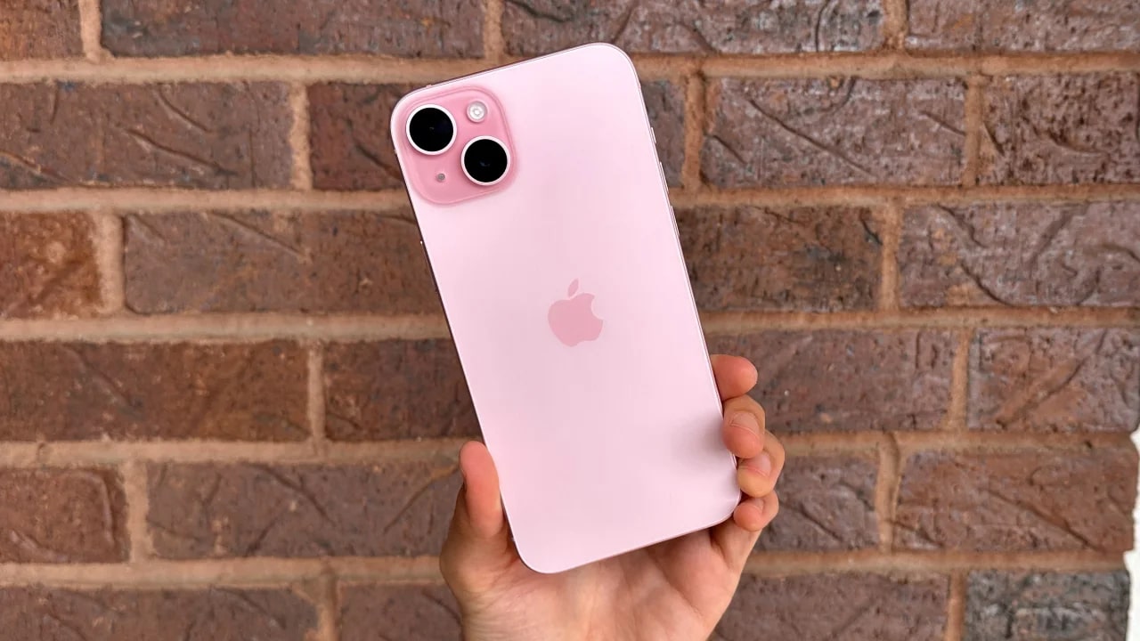 Person holding pink iPhone 15