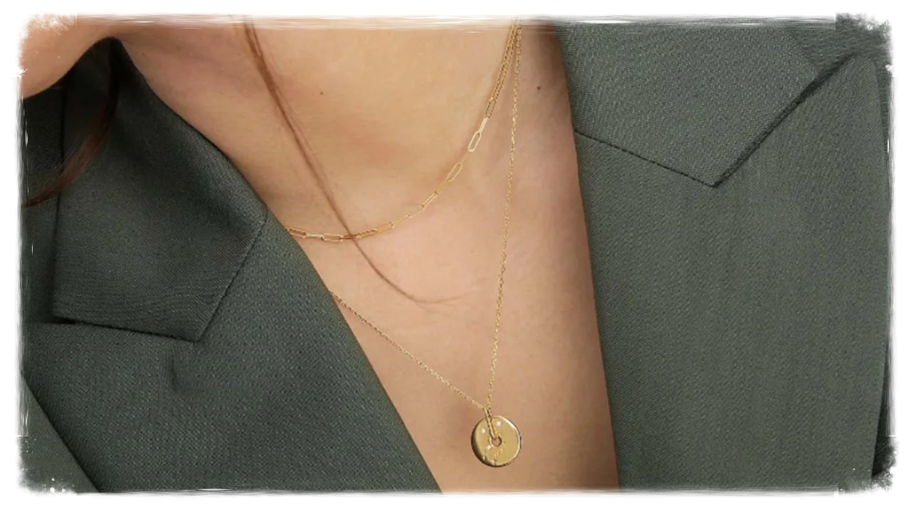 Person wearing circular gold necklace
