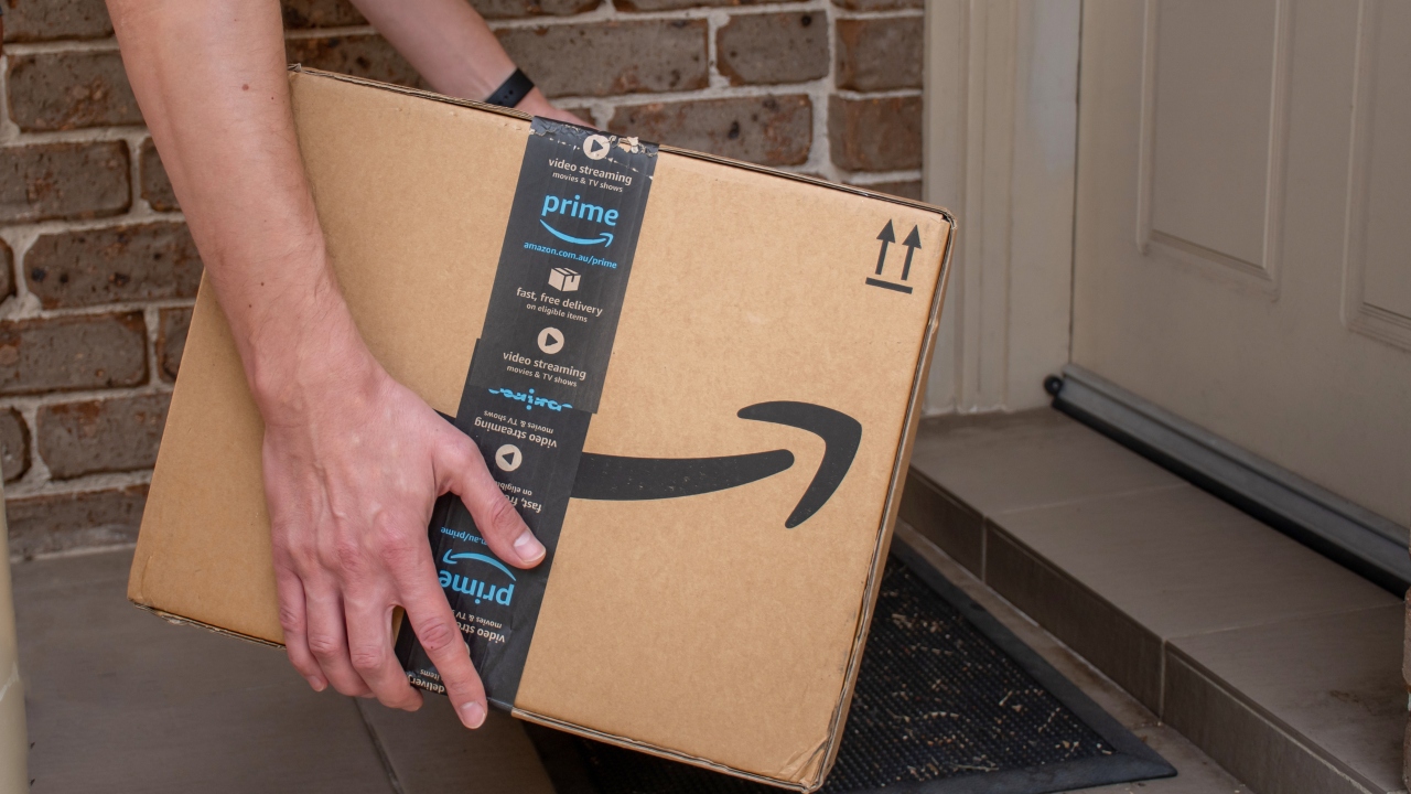 Person holding cardboard Amazon box