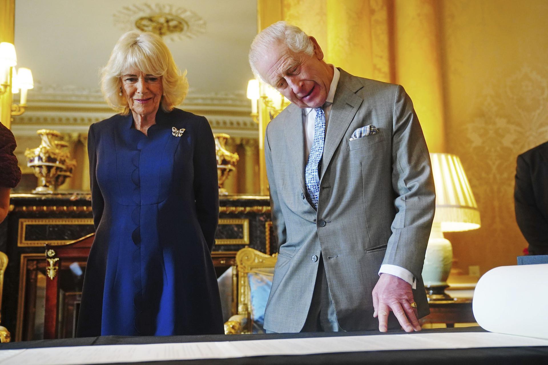 King Charles III and Queen Camilla are presented with the Coronation Roll, an official record of their Coronation on Wednesday.