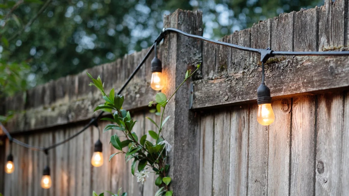 String lights on a wooden fence