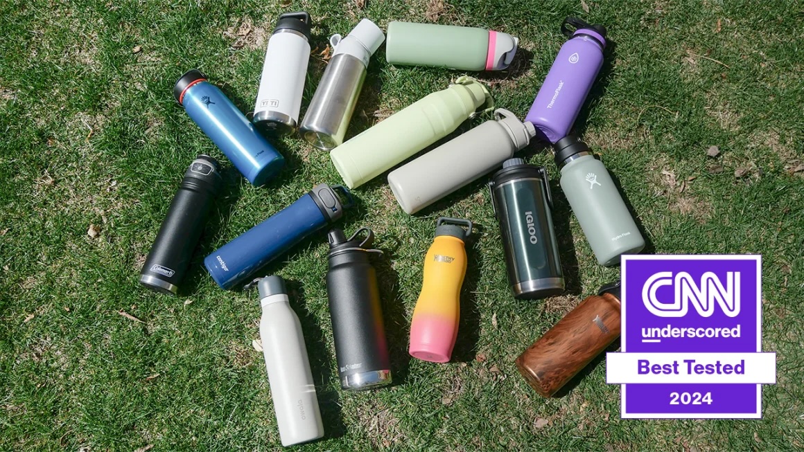 Water bottles lined up outside on grass with CNN best tested logo in the corner