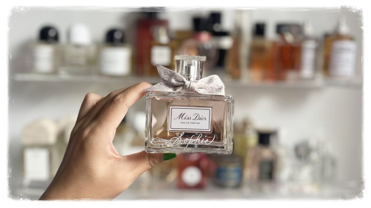 Person holding Miss Dior perfume