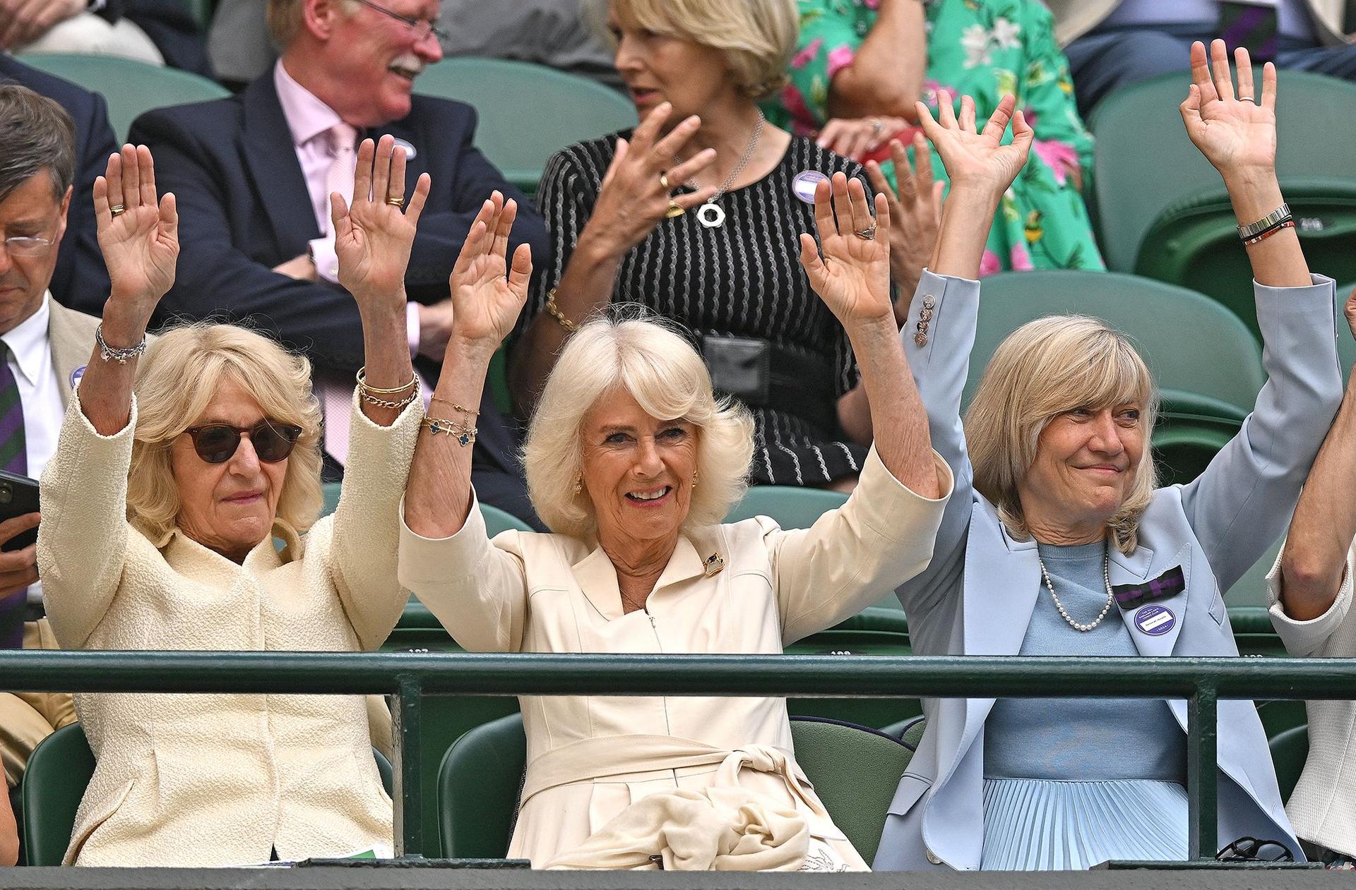 Queen Camilla takes part in a Mexican wave to cheer on US tennis player Taylor Fritz and Italy's Lorenzo Musetti during their men's singles quarter-finals on the 10th day of Wimbledon on Wednesday.