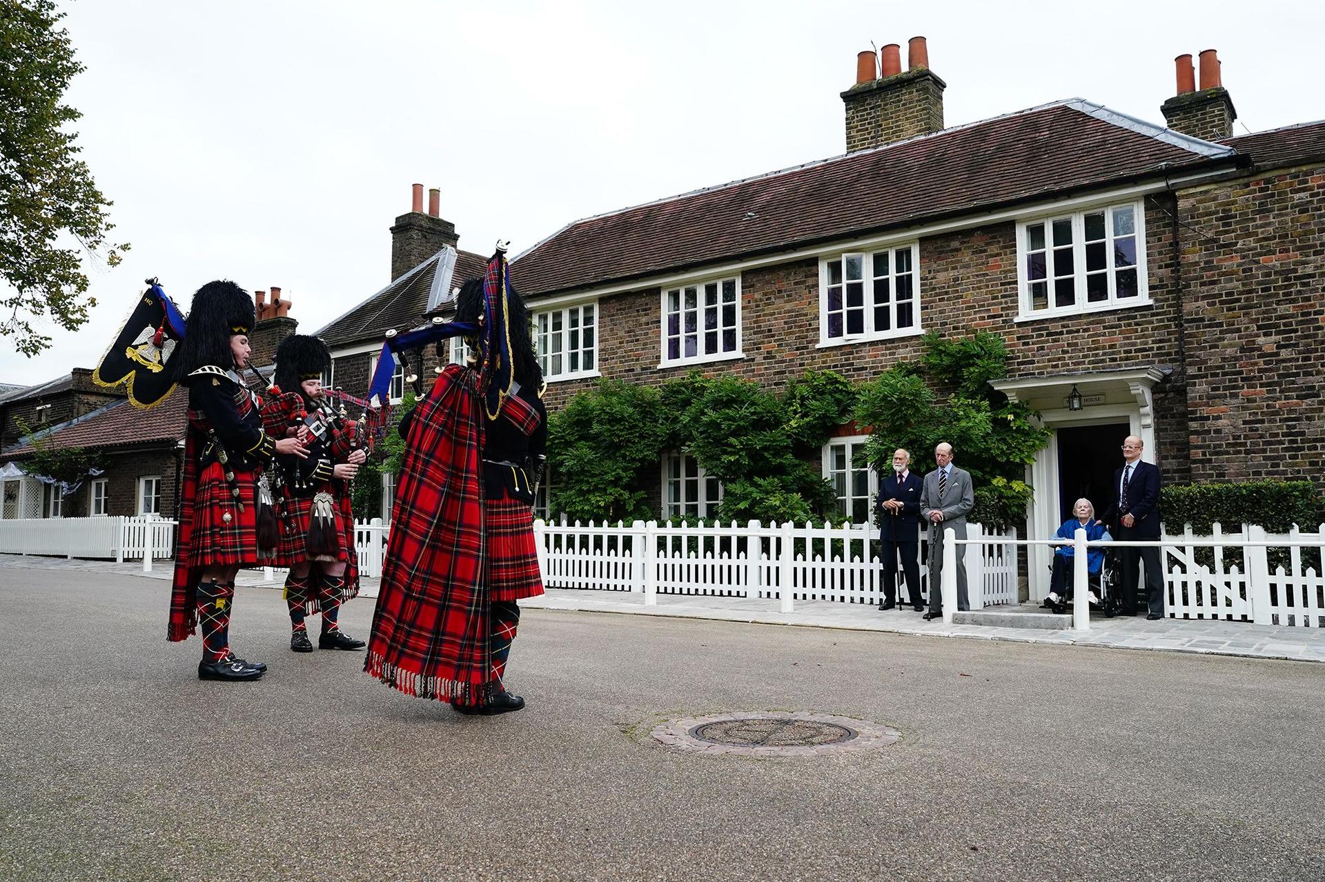 Prince Michael of Kent (4th R) and Prince Edward, Duke of Kent (3rd R), watch three pipers from the Royal Scots Dragoon Guards (Carabiniers and Greys) play outside Wren House, Kensington Palace to mark Prince Edward's 89th birthday, on October 9, 2024.