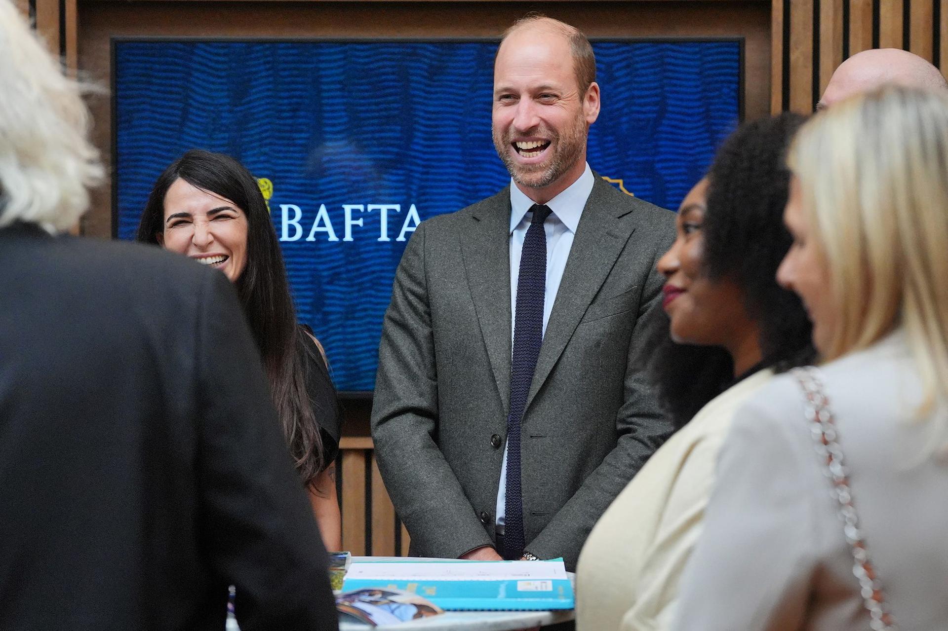 Prince William laughs with students at BAFTA bursary event.