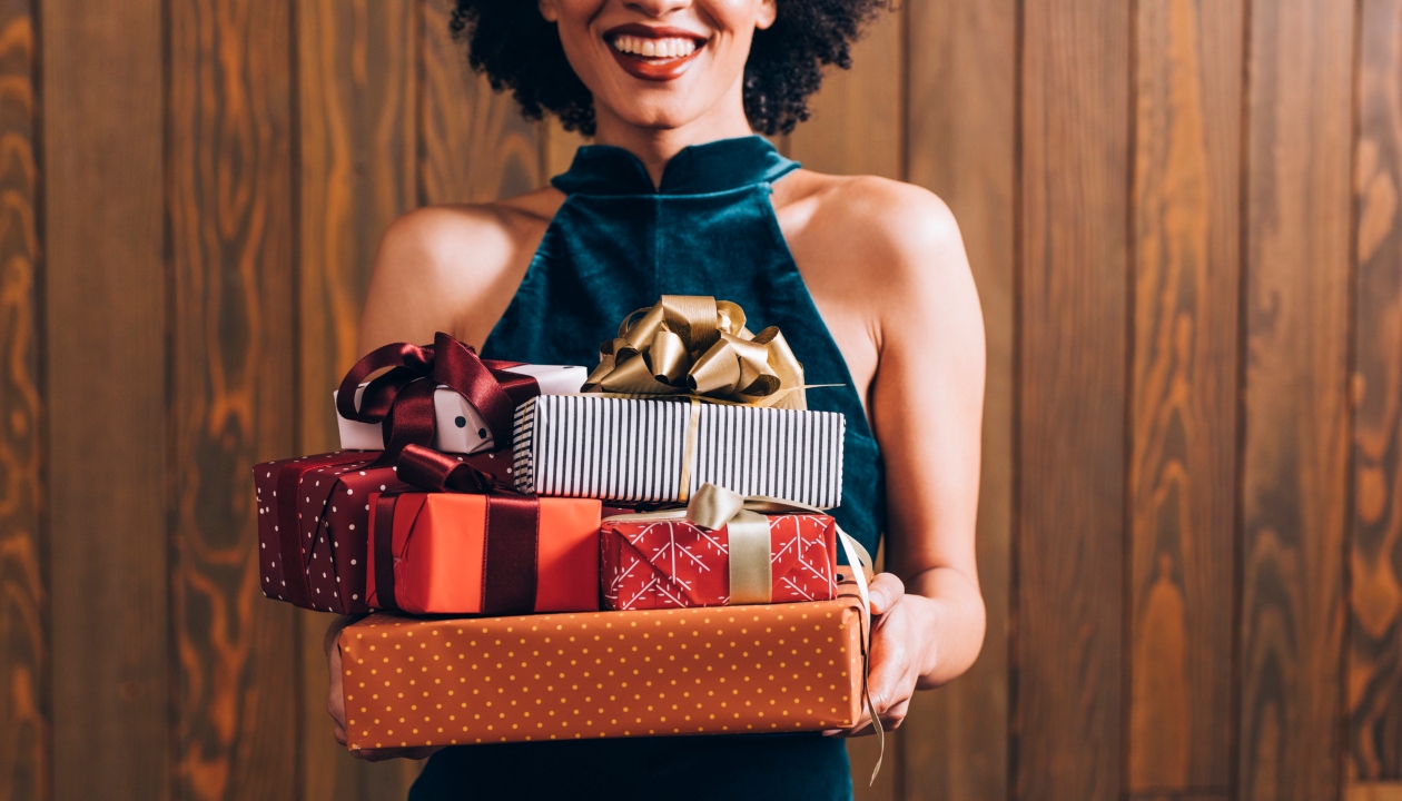 Person holding a stack of gifts
