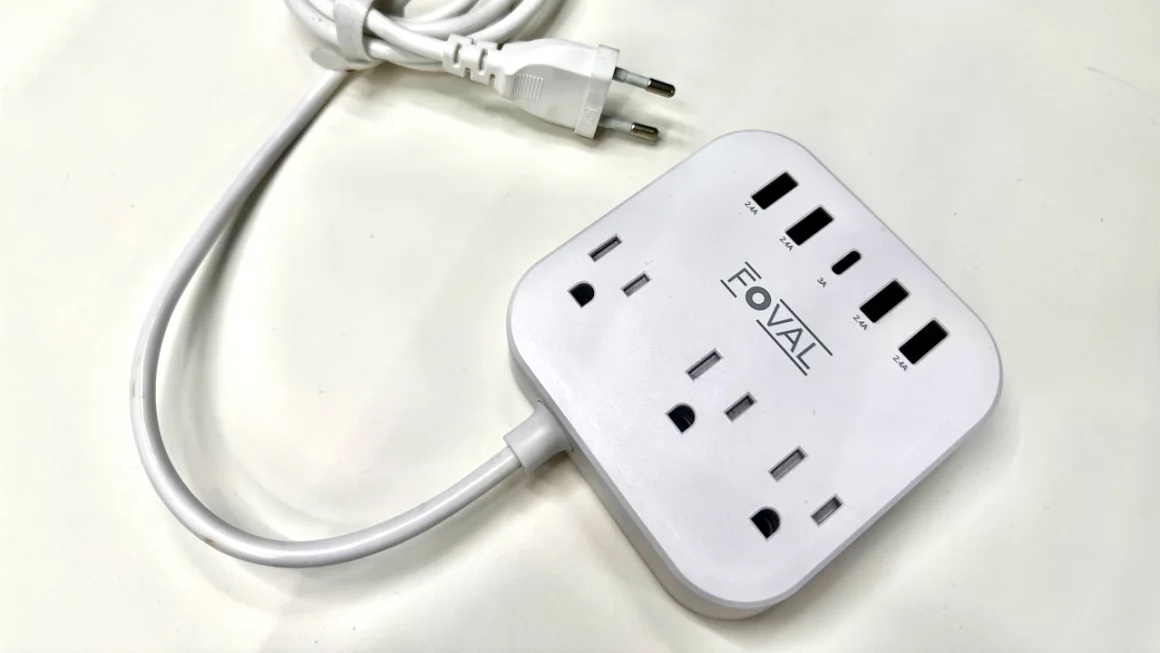 The foval European travel adapter nestled against a white surface