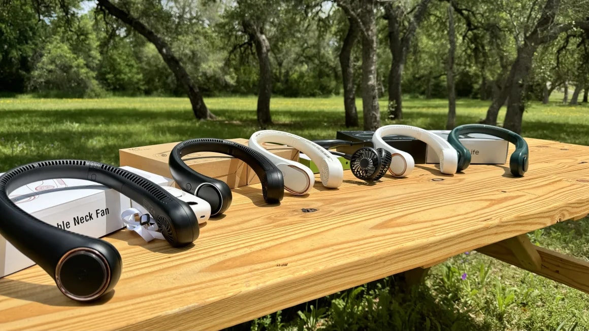 Six neck fans on a wooden bench