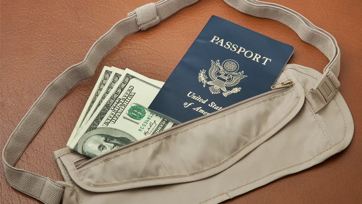 Tan money belt with bills and passport