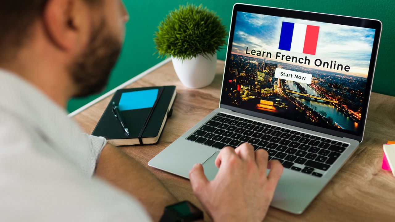 Person learning French on a laptop