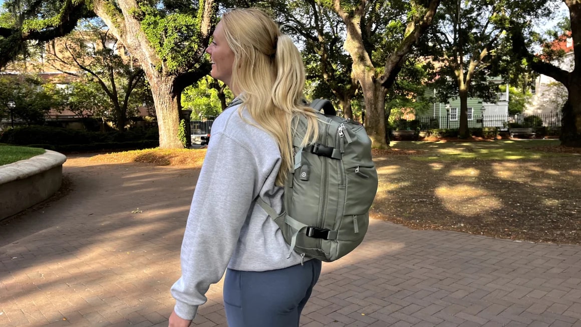 Blonde woman wearing the Coowoz Large Travel Backpack