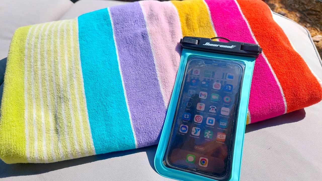 Waterproof phone case on a striped towel