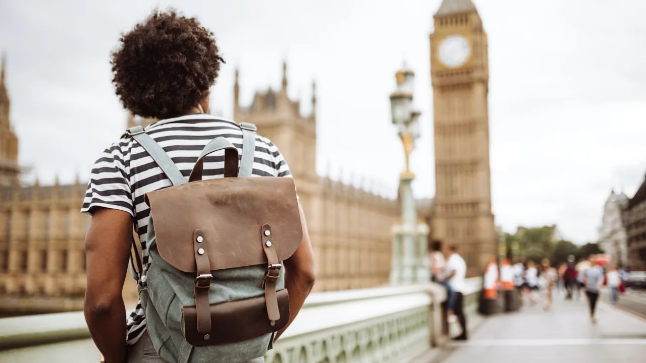 Person wearing backpack facing Big Ben