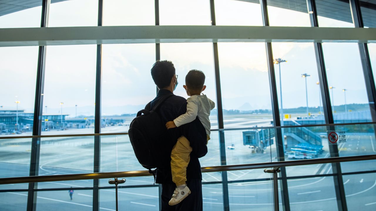 Person holding a child in an airport