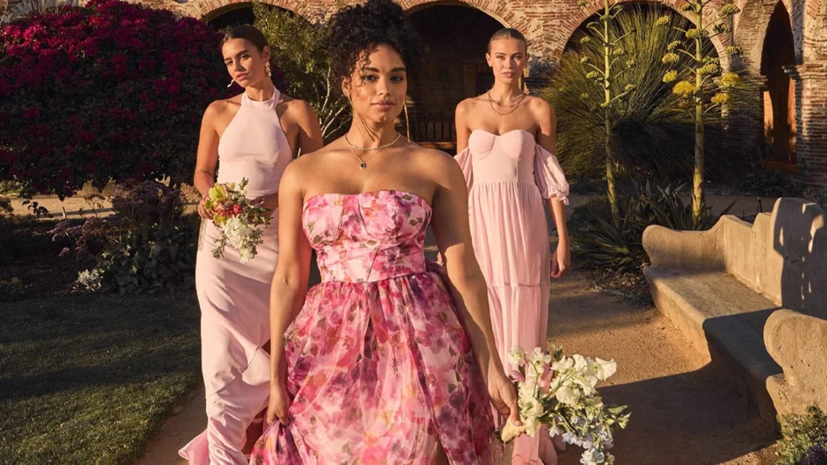 Three women in pink formal dresses