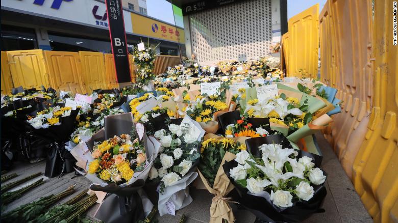 Flowers are placed as tributes in front of the Shakou Roadsubway station in memory of flood victims in Zhengzhou