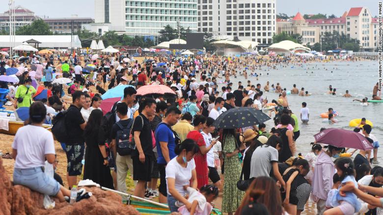 People swarm to the beach in the summer heat in Qingdao, China, on July 10.