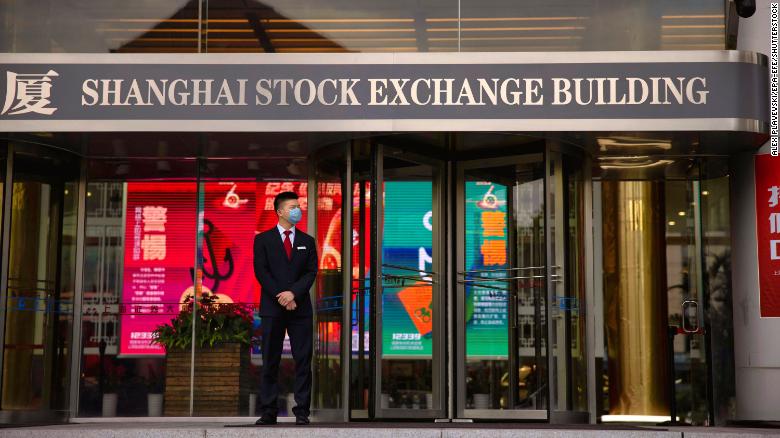 A man stands in front of the Shanghai Stock Exchange Building in Shanghai, China, 29 October 2020.