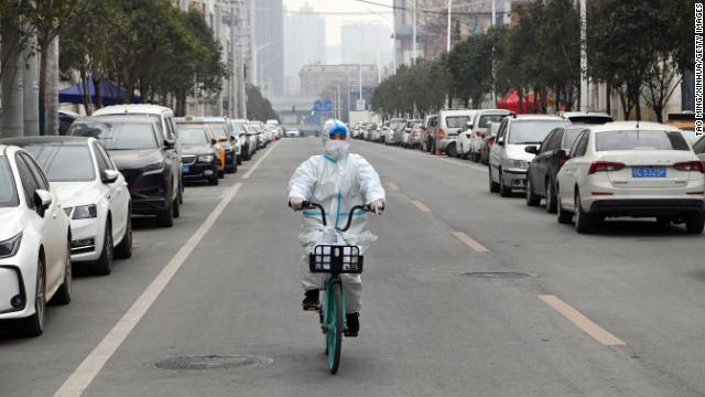 A drug store worker rides a bicycle to deliver medicine in Xi'an, a city under lockdown in northwest China's Shaanxi Province, on December 31, 2021.