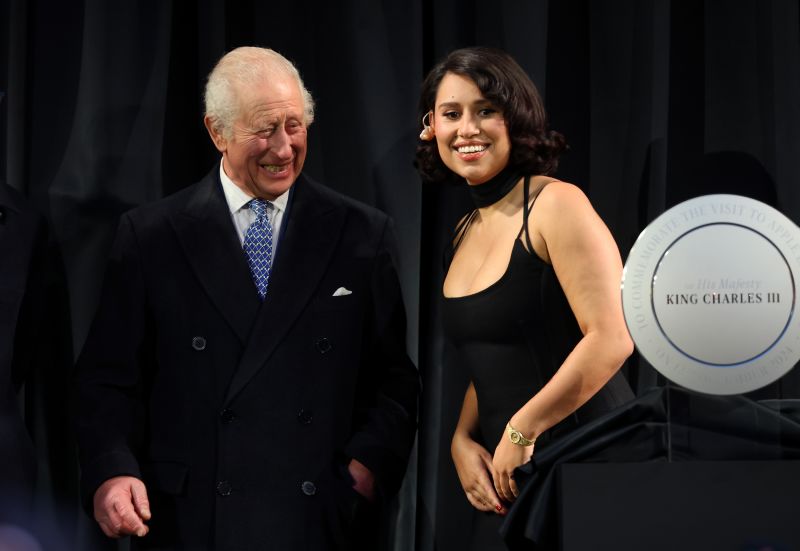 King Charles and British singer-songwriter Raye smile for the cameras as they share the stage at an event at the redeveloped Battersea Power Station in London, England on 12th December.