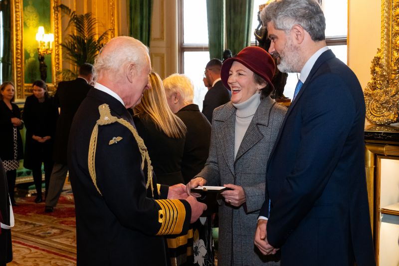 King Charles presents an Elizabeth Emblem, a new tribute to the next of kin of former firefighters, police officers and other public servants who died in the line of duty, to Jane Houng.