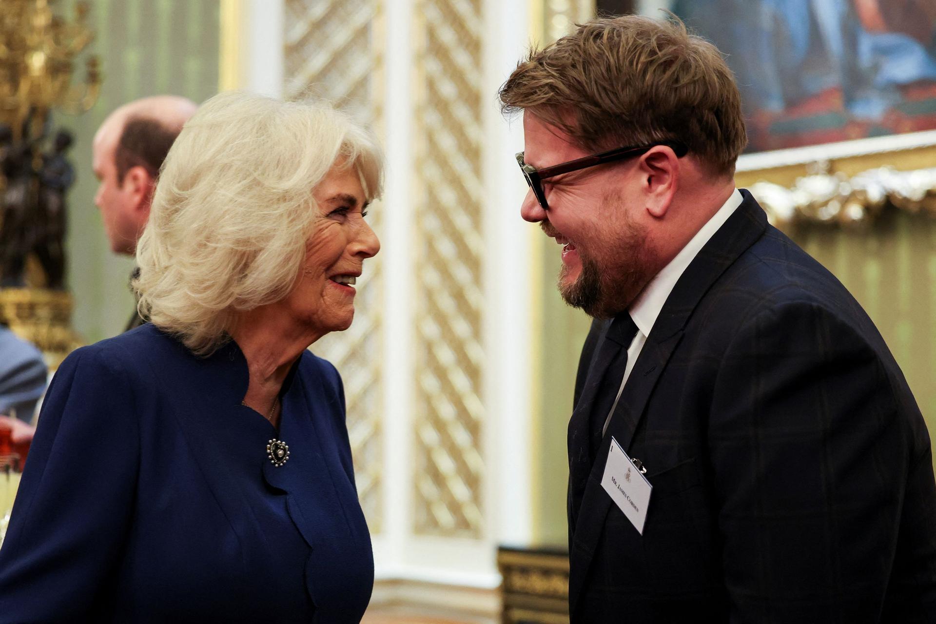  Queen Camilla speaks with actor James Corden, as she attends a reception for staff, actors and supporters of the National Theatre at Buckingham Palace on February 18, 2025 in London, England.